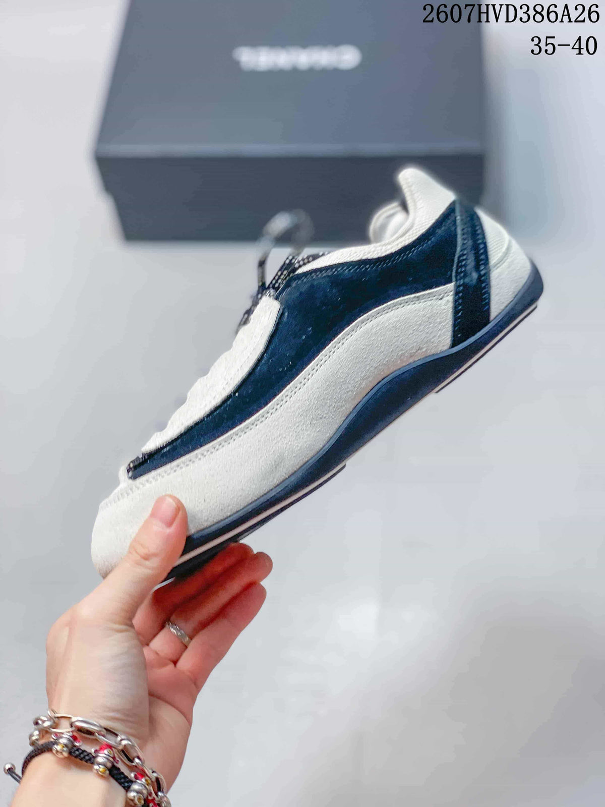 Side profile showing the low-top silhouette, black-and-white color blocking, and layered side panels.