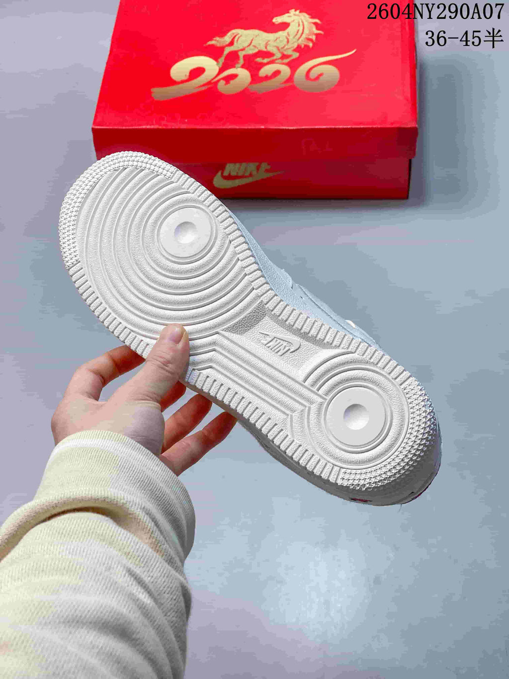White sneaker outsole showing the circular traction pattern and textured rubber tread.