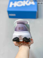 Rear view of the shoe showing the padded heel, mint accents, white midsole, and black outsole details.