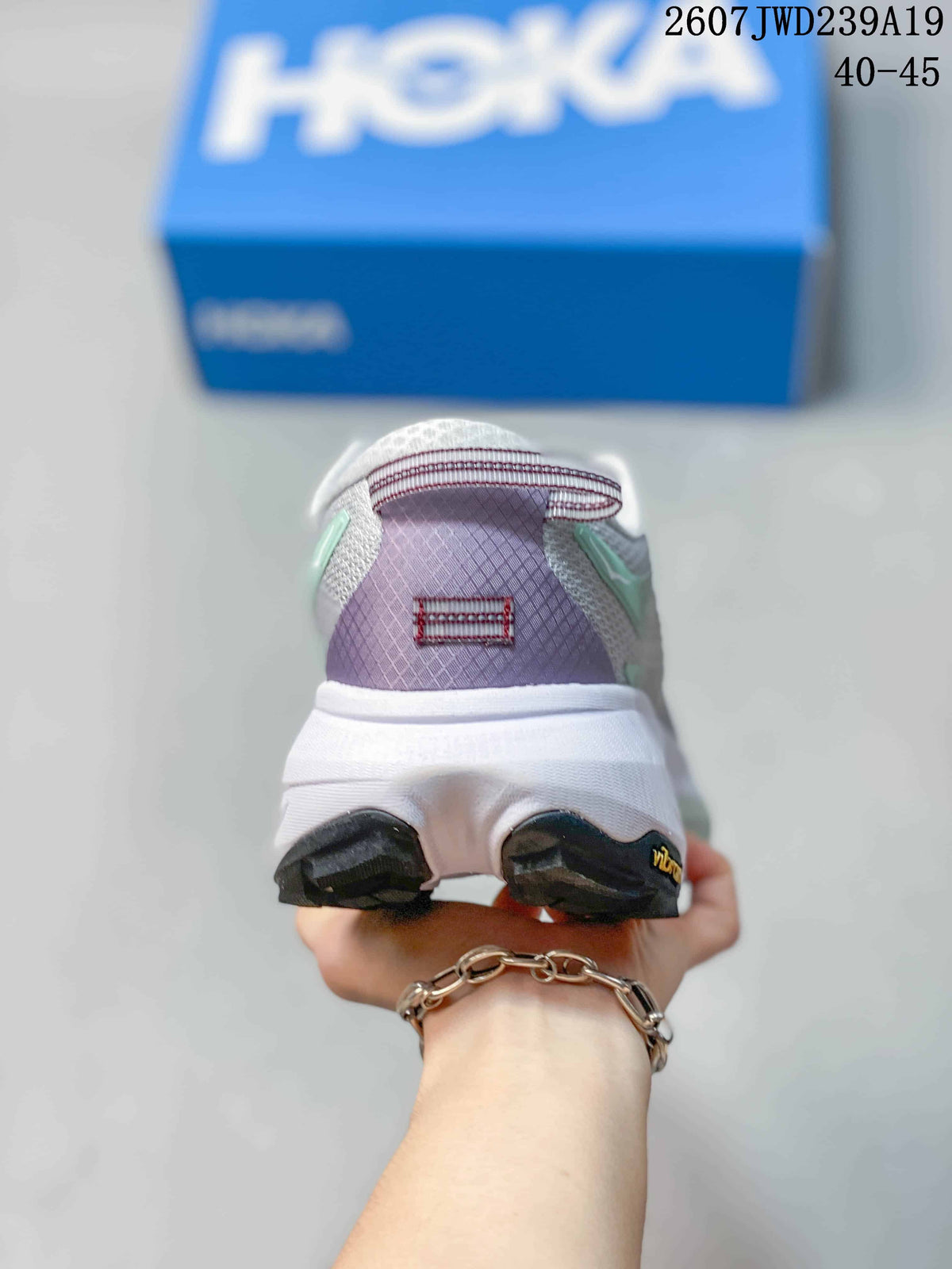 Rear view of the shoe showing the padded heel, mint accents, white midsole, and black outsole details.
