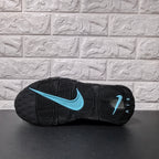 Outsole view with black tread and a light blue Nike Swoosh
