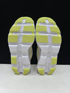 Outsole view showing lime tread sections on the Cloudmonster 2 shoes.