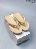 Pair of beige New Balance thong sandals displayed on a branded shoe box; image text shows style code 2607YD936A26 and sizes 36–45.