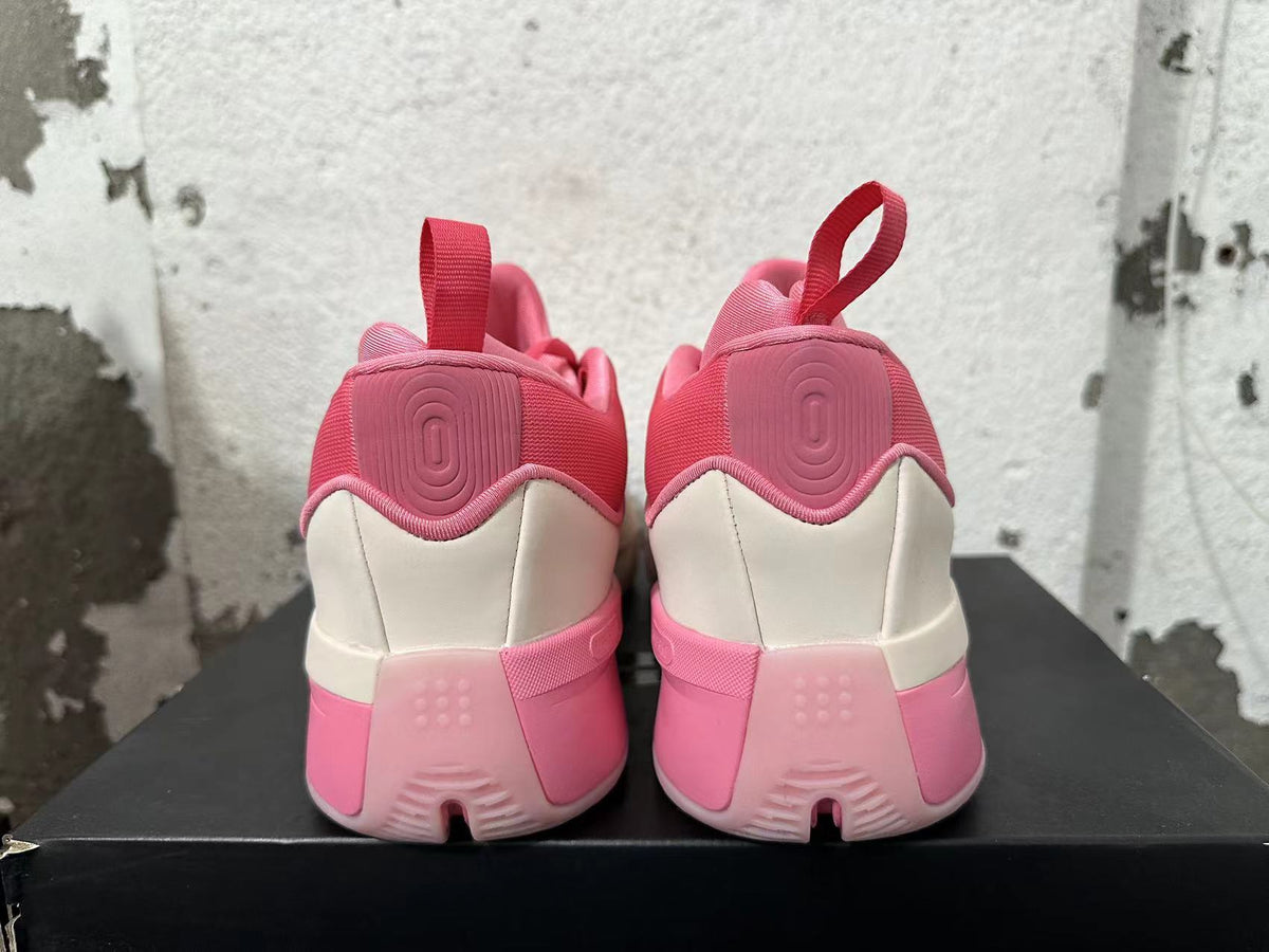 Rear view of the pink and cream Adidas Dame 9 basketball shoes