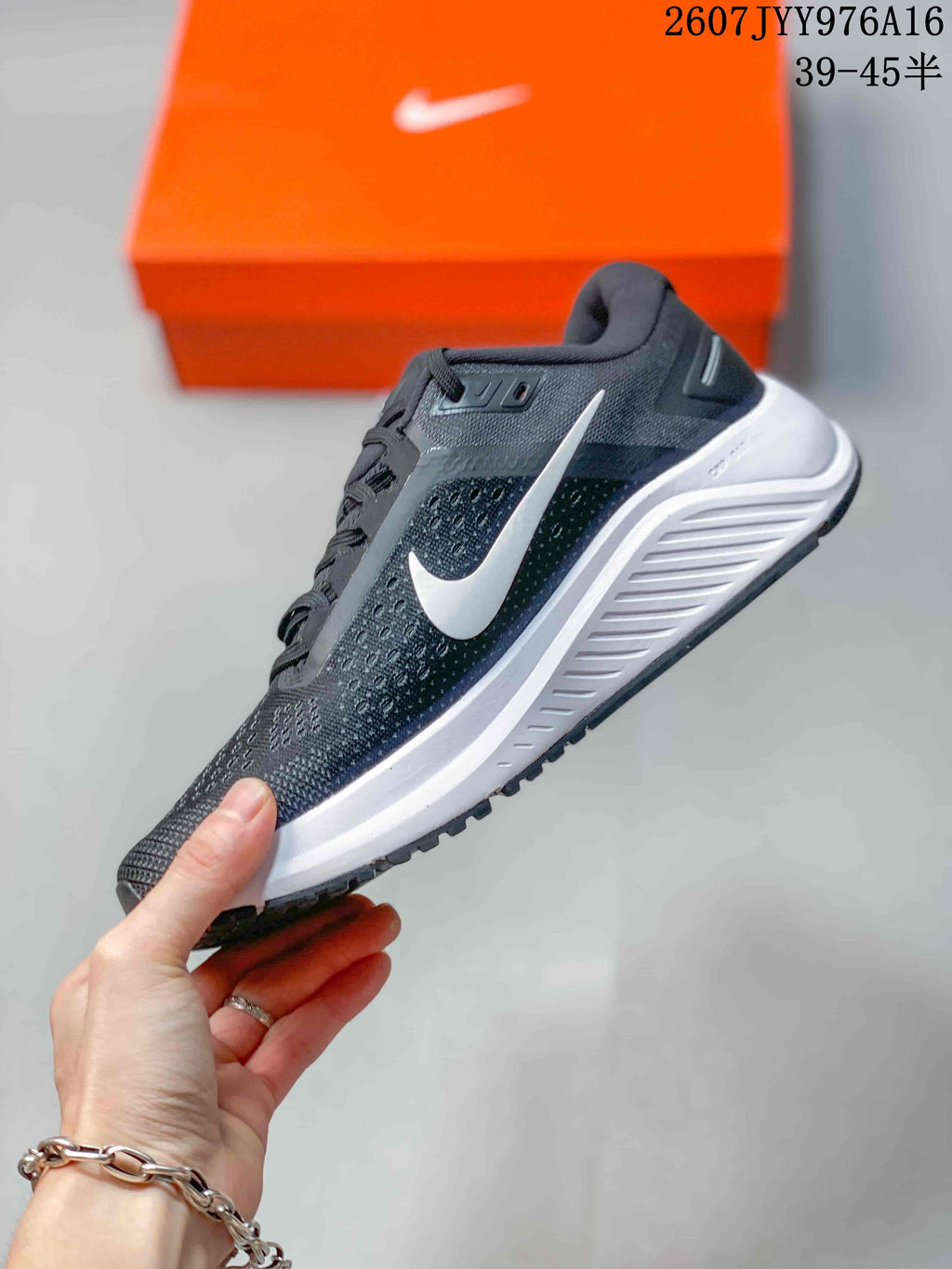 Side profile showing the white Nike Swoosh, mesh-textile upper, white midsole, and black outsole.