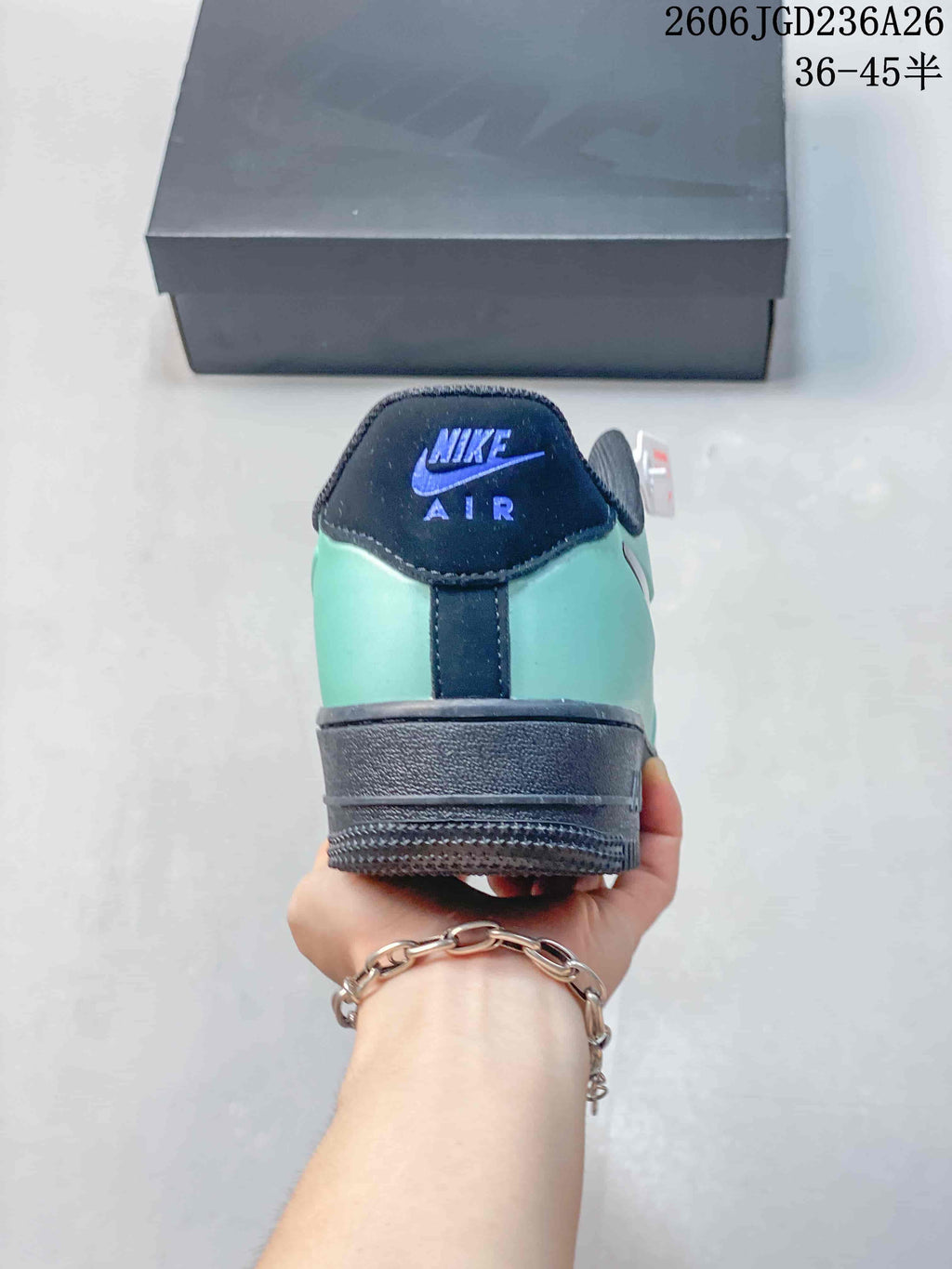 Rear view showing the mint-green heel and navy heel tab