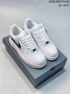 White Nike Air Force 1 '07 low-top sneakers on a box; the side logos appear glossy black.