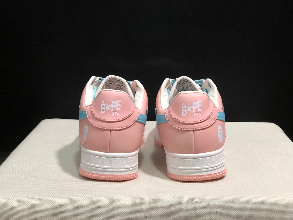 Rear view of the pink Bape Sta sneakers showing white heel branding, light-blue side accents, and pink outsoles.
