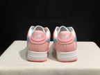 Rear view of the pink Bape Sta sneakers showing white heel branding, light-blue side accents, and pink outsoles.