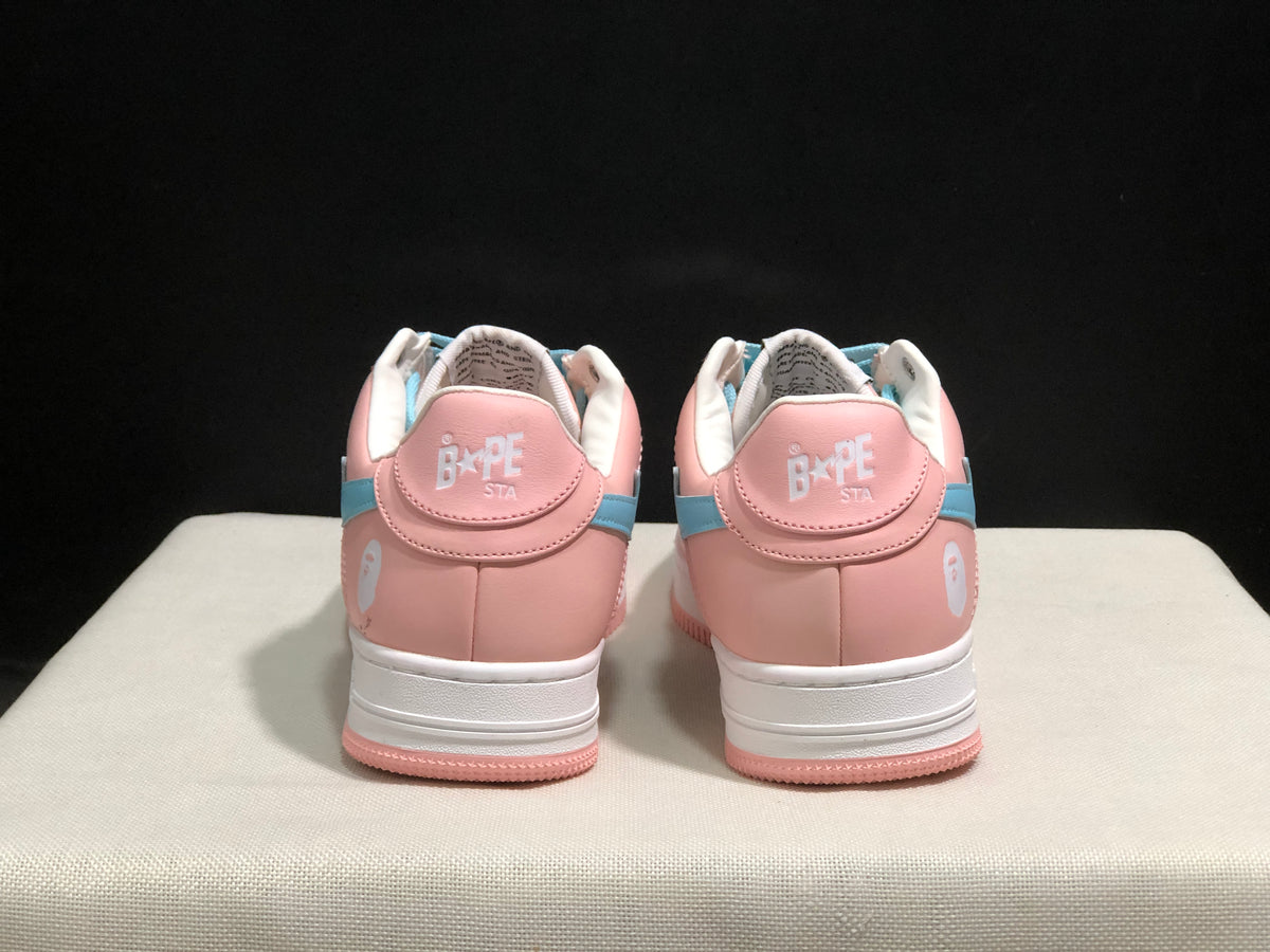 Rear view of the pink Bape Sta sneakers showing white heel branding, light-blue side accents, and pink outsoles.