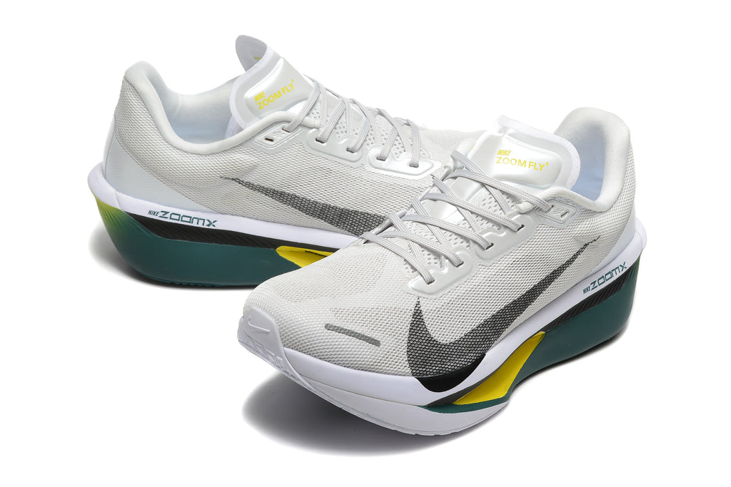 Pair of off-white Nike Zoom Fly 6 shoes with dark green midsoles and yellow accents