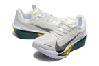 Pair of off-white Nike Zoom Fly 6 shoes with dark green midsoles and yellow accents