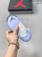 Underside view of the sneaker showing a light-blue translucent outsole with herringbone-style tread and Jordan branding.