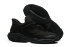 All-black basketball shoe shown with patterned outsole.