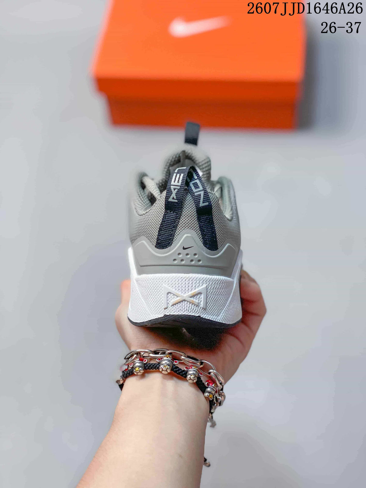 Rear view highlighting the heel structure, pull tabs, and Nike branding on the gray and white children's sneaker.