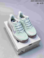 Pair of pale mint Nike ACG Pegasus Trail sneakers displayed on a branded shoebox.
