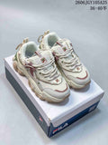 Pair of cream FILA Fusion chunky sneakers with mauve and green accents on a shoe box