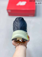 Rear view of the New Balance RC Elite shoe showing the dark navy heel, light midsole and separated outsole sections.