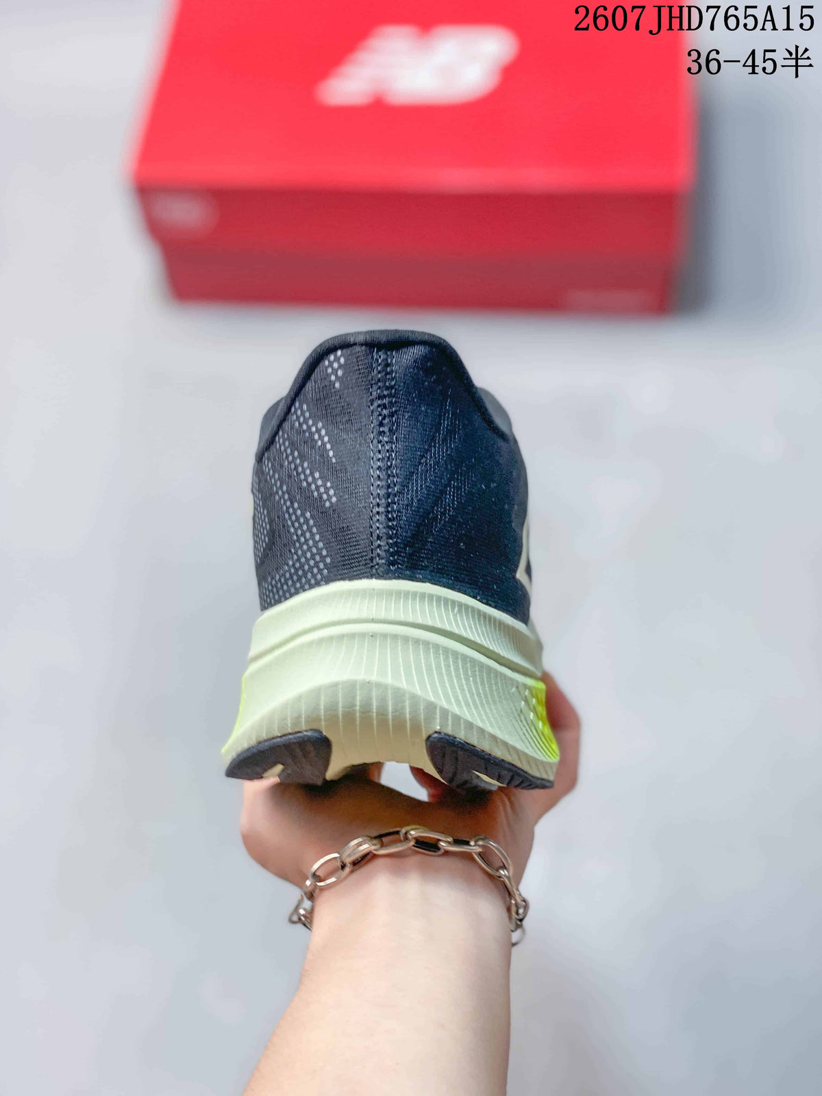 Rear view of the New Balance RC Elite shoe showing the dark navy heel, light midsole and separated outsole sections.