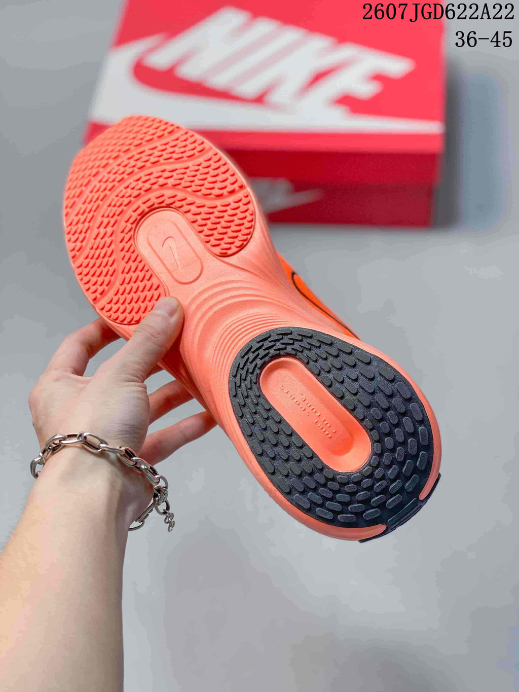 Close view of the textured orange and black outsole on a Nike Uplift SC sneaker.