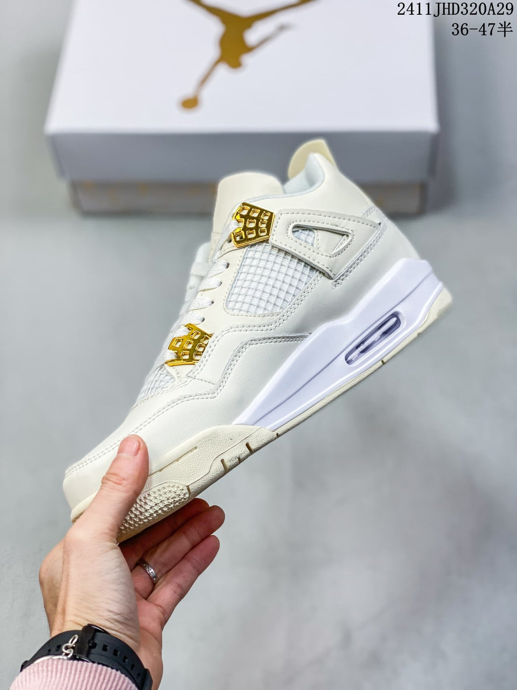 Side view of the white and gold sneaker showing mesh panels, lace hardware, and the visible air unit in the midsole.