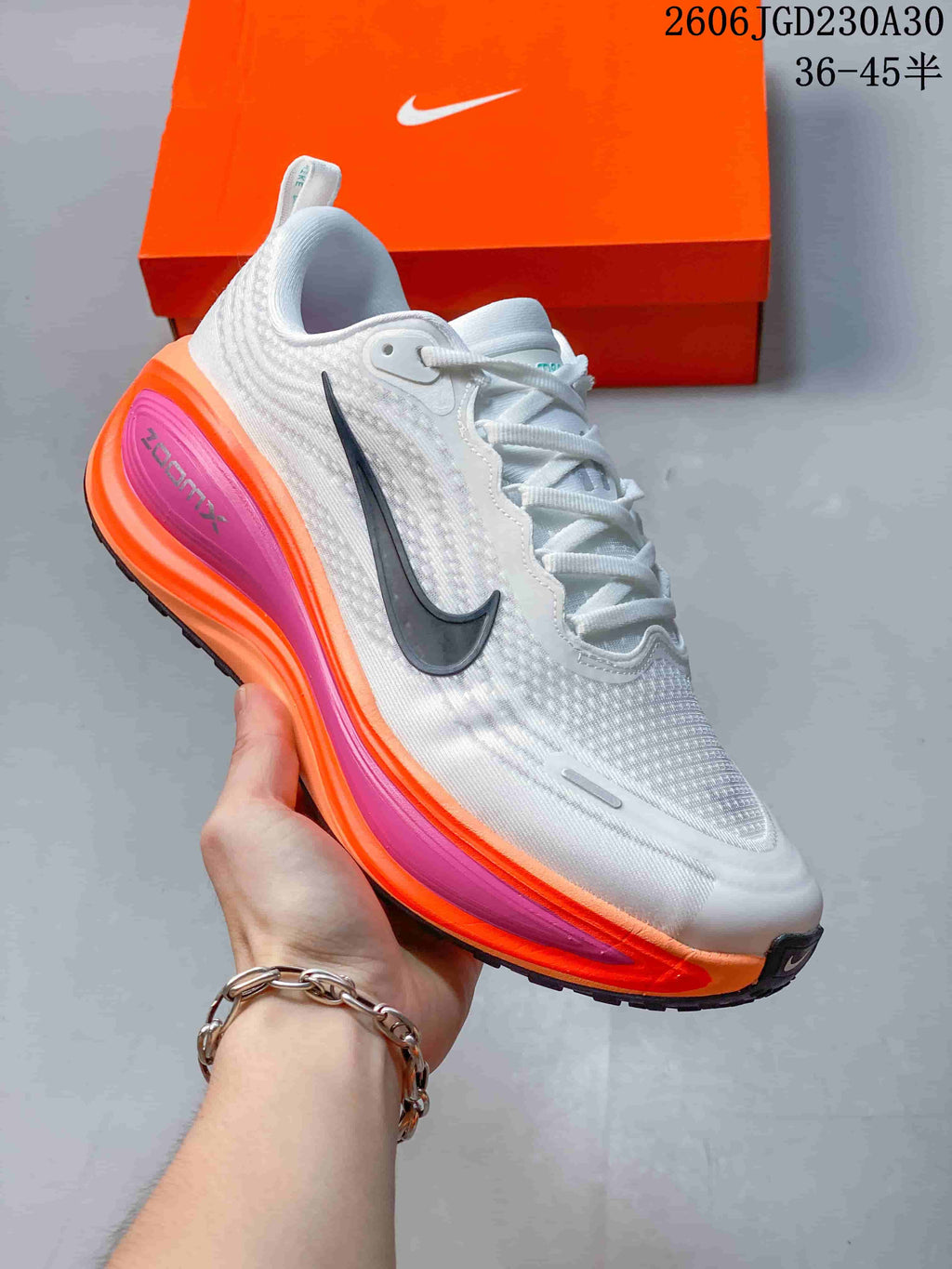 Angled side view highlighting the dark Swoosh and bright orange and pink accents.