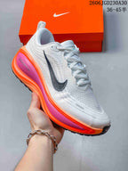 Angled side view highlighting the dark Swoosh and bright orange and pink accents.