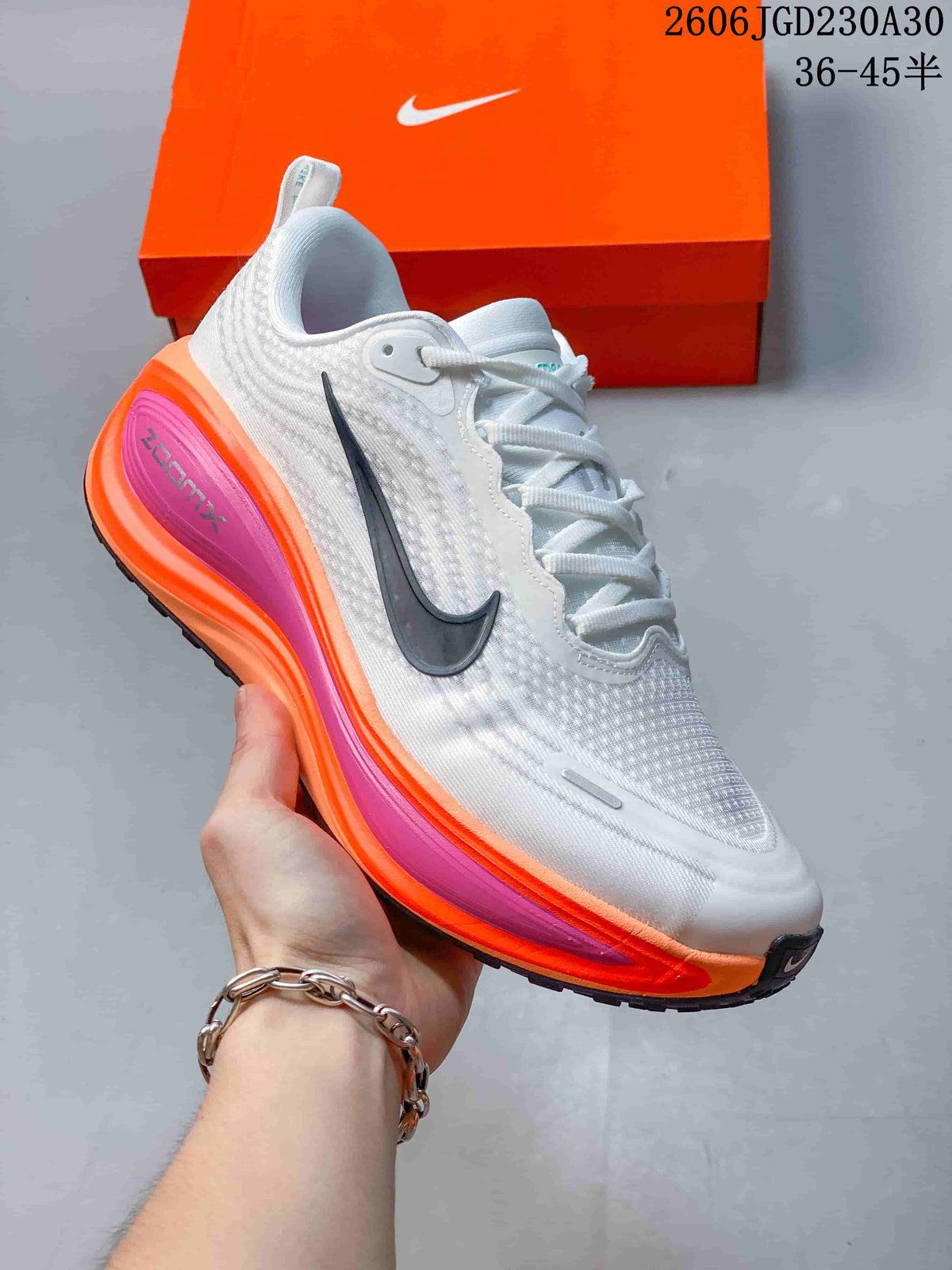 Angled side view highlighting the dark Swoosh and bright orange and pink accents.