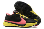 Black basketball shoes with a pink Swoosh, yellow laces, and bright yellow accents.