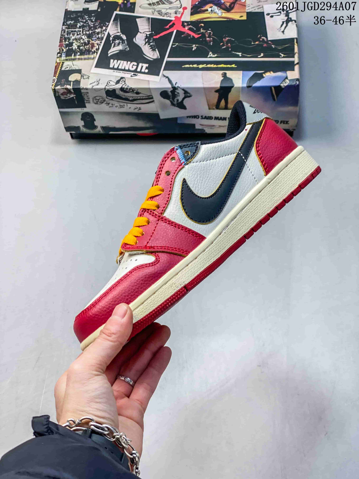 Side profile showing the red and white upper, contrasting dark side logo, yellow trim, and light-colored midsole.