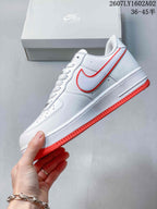 Side view of a white Nike Air Force 1 ’07 sneaker with a red-trimmed Swoosh and red outsole.