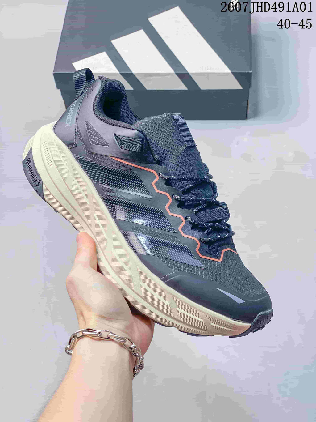 Dark gray Adidas Terrex low-top shoe with a light sole and orange detailing; image displays the size range 40–45.