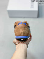 Rear view showing the brown heel, blue midsole accent, and Loewe branding on the heel tab.
