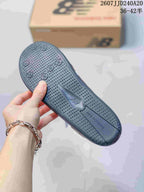 Close-up of the dark outsole showing raised circular traction elements and a textured tread pattern.