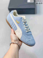 Light blue PUMA sneaker with a white side stripe, gold side branding, and a gum-colored outsole.