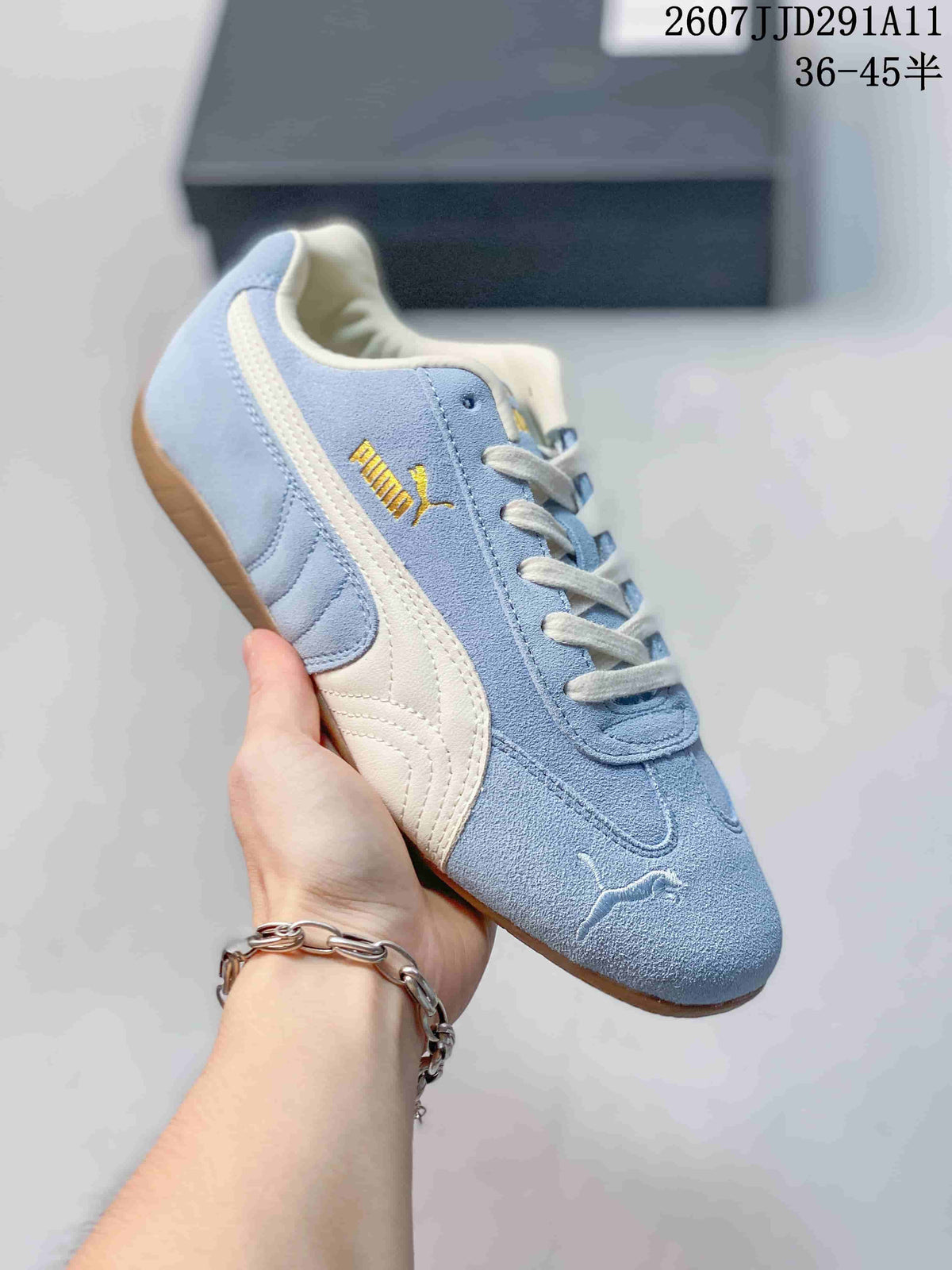 Light blue PUMA sneaker with a white side stripe, gold side branding, and a gum-colored outsole.