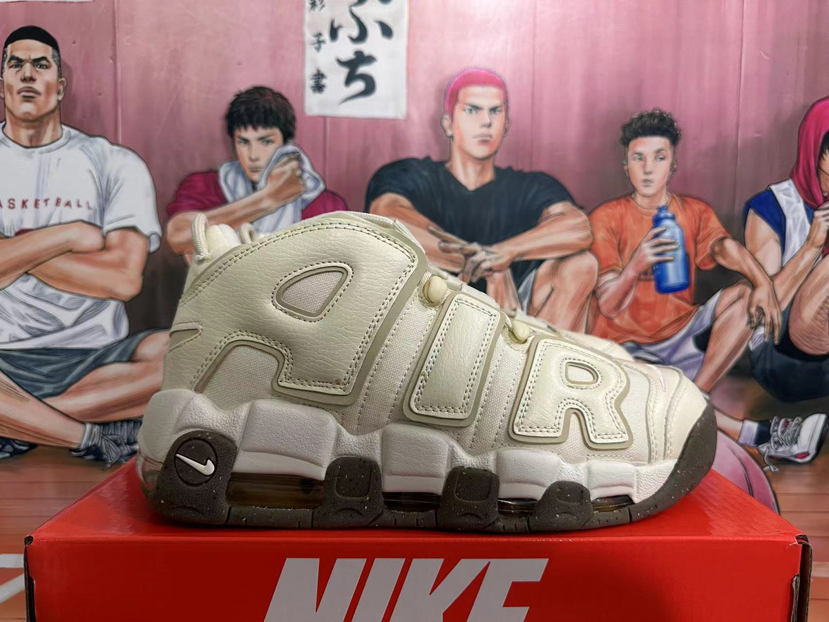 Side profile of a cream Nike Air More Uptempo sneaker showing oversized AIR lettering.