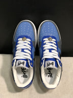 Top-down view showing the blue perforated toe boxes, white laces, and tongue branding.