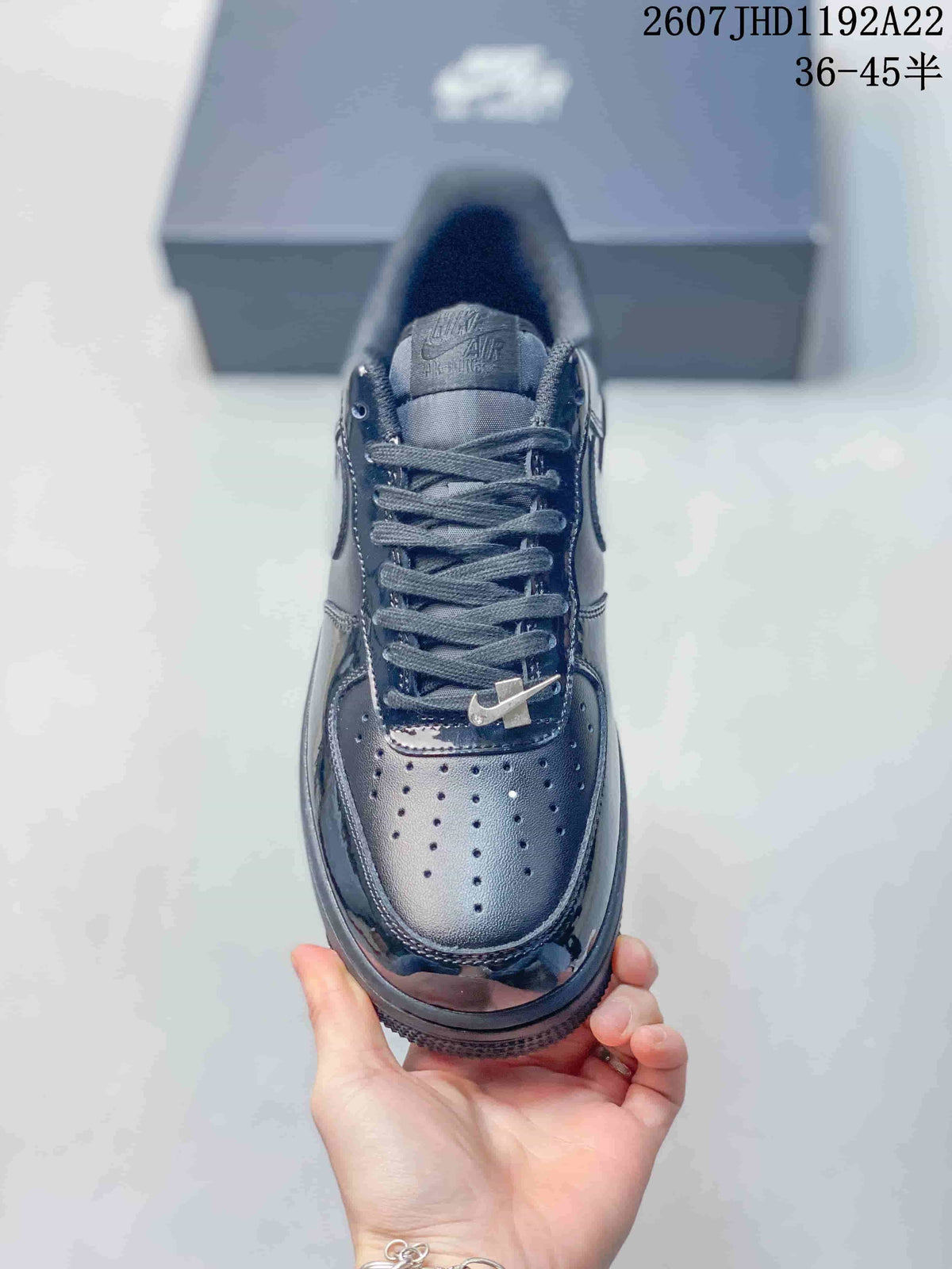 Top view of the black sneaker showing the perforated toe box, flat laces and padded tongue.