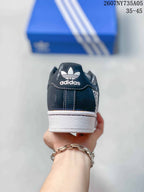 Rear view showing the black heel panel, white Adidas trefoil branding, and white midsole.