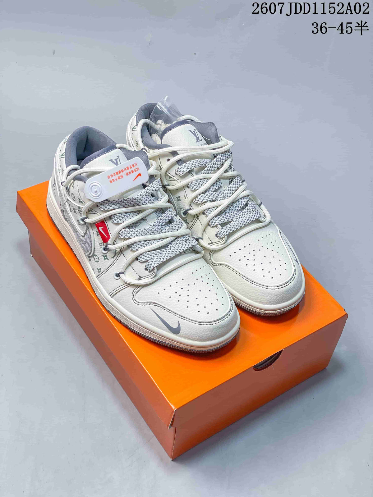 Pair of white low-top sneakers with repeating patterned panels and gray patterned laces.