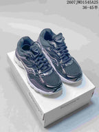 Pair of dark Saucony ProGrid Omni 9 sneakers shown on a white shoebox, with the product code and size range overlaid at the top.