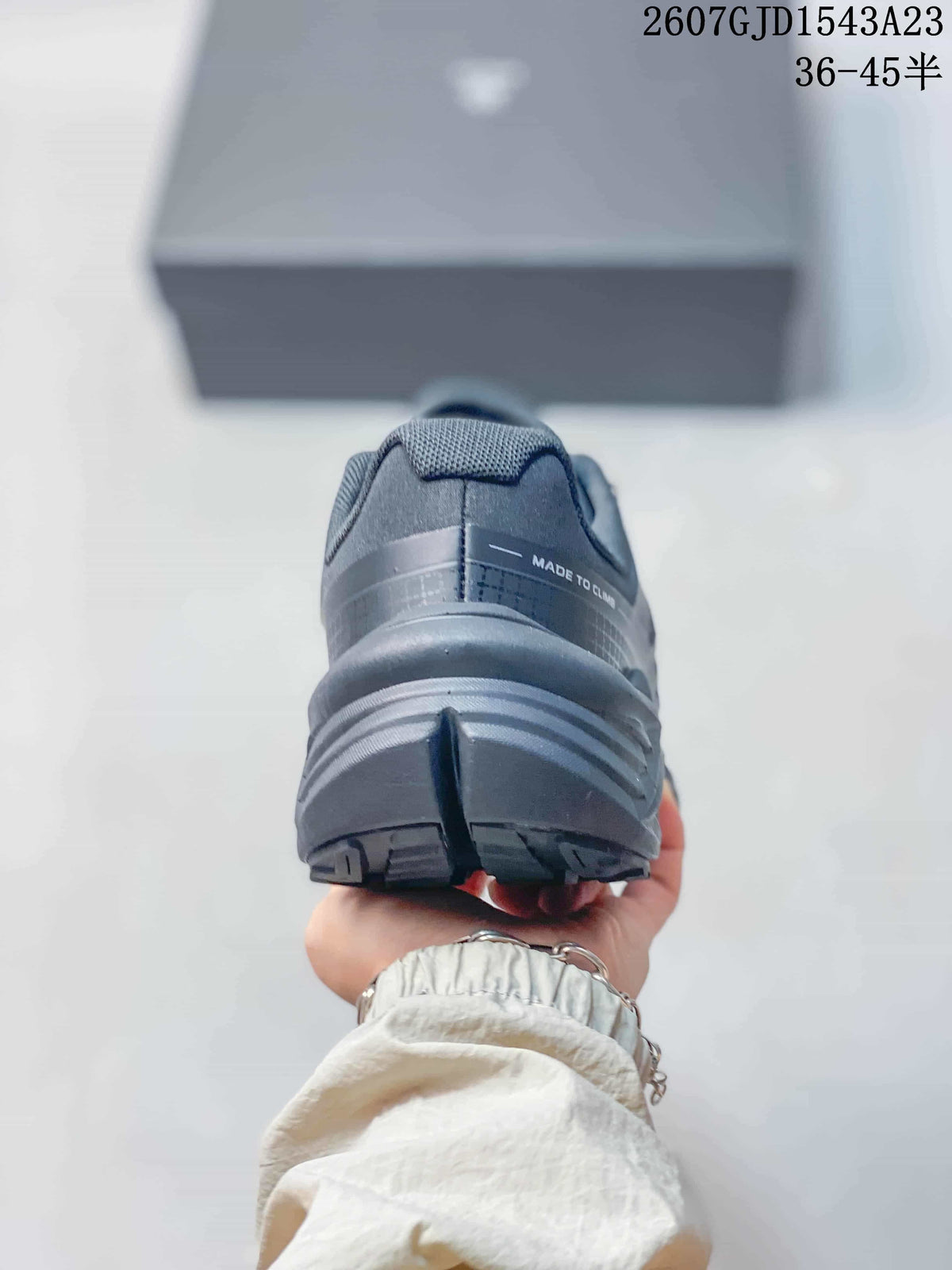 Rear view showing the padded heel collar, layered heel structure, and outsole tread.
