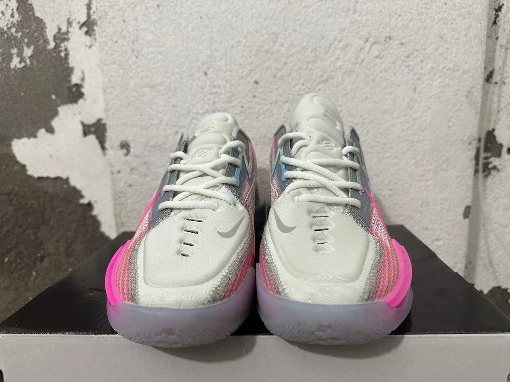 Front view showing the laces and toe details of pink and grey Nike GT Cut 3 shoes