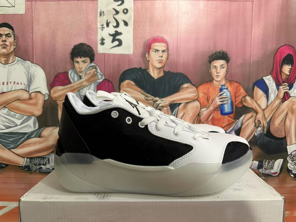 Side view of a black and white low-cut Jordan basketball shoe.