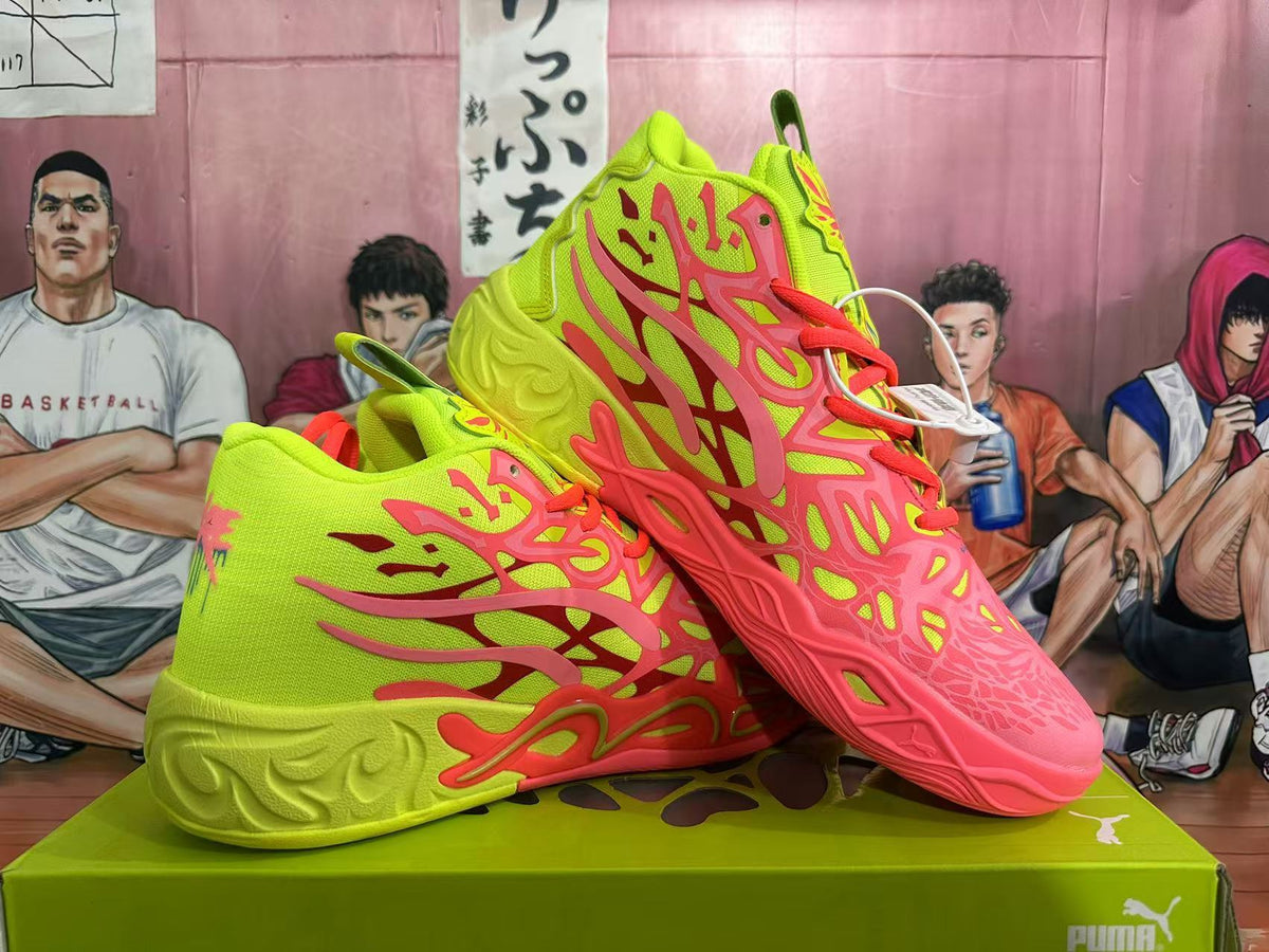 Two lime green and coral PUMA basketball sneakers displayed together on a green shoe box.