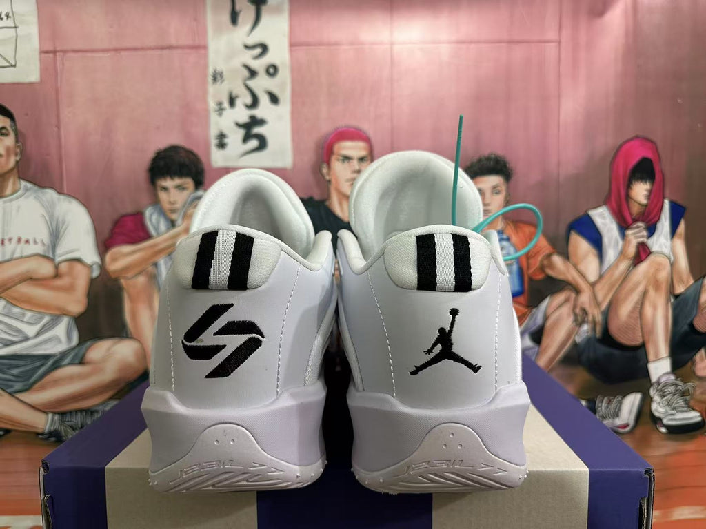 Rear view of white Jordan sneakers with black heel logos and striped heel tabs