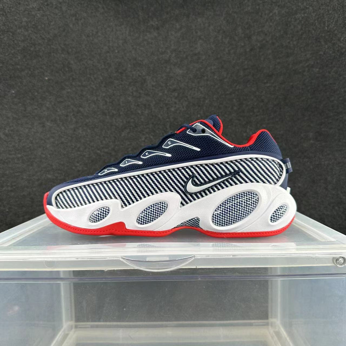 Side view of a navy, white, and red Nike Zoom Flight 95 sneaker with patterned panels and oval midsole details.