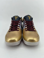 Front view of the pair showing perforated gold toe boxes and red-and-black laces.