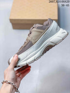 Side profile showing the layered upper, side overlay, reinforced heel area, and thick sculpted sole.